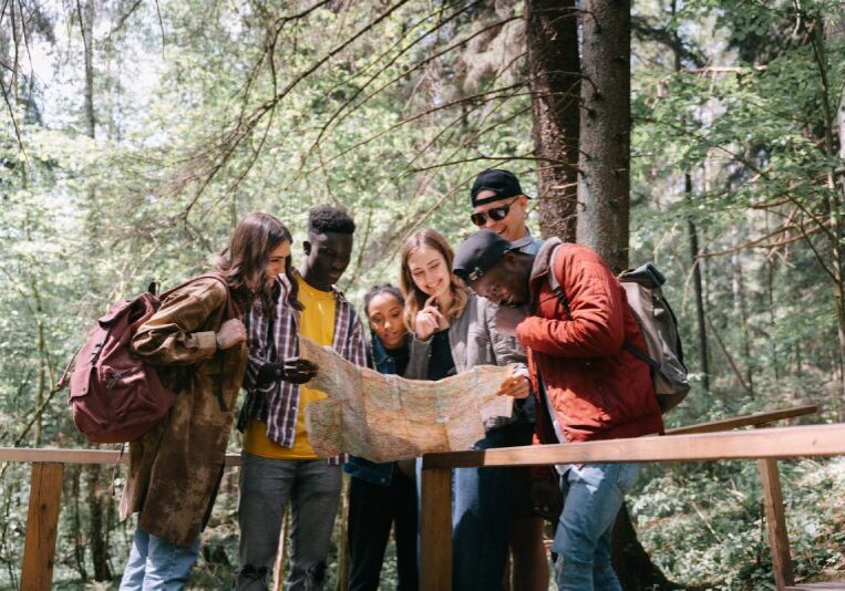 A group of people standing around looking at a map.